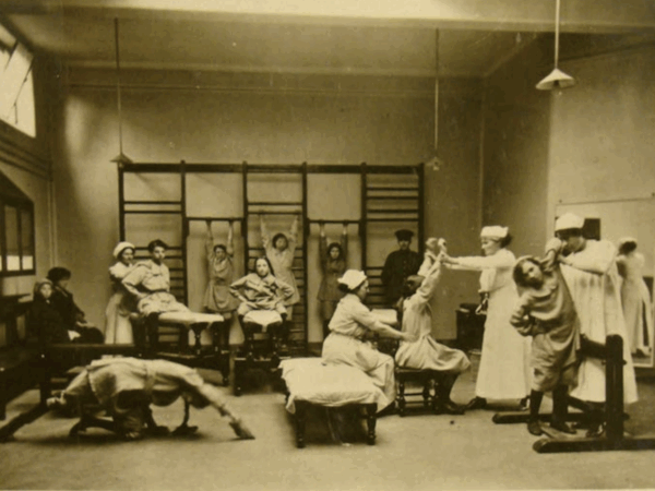 Gymnasium at King's College Hospital, London with female patients and staff. c1900.