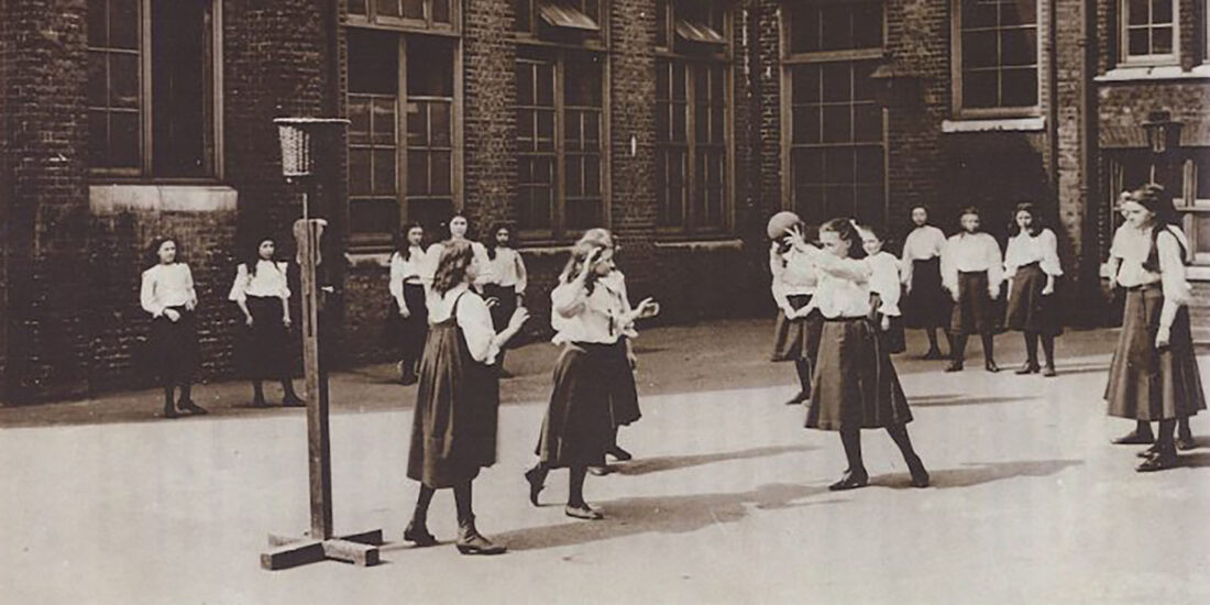 Netball in the playground of William Street Girls School, London. c1908. Note the wastepaper baskets used as goals.