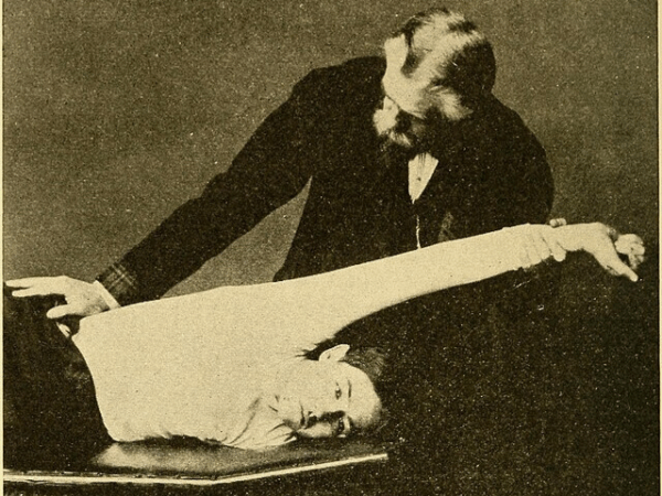 Stretching the Latissimus Dorsi Muscle. c 1906. Wikimedia Commons